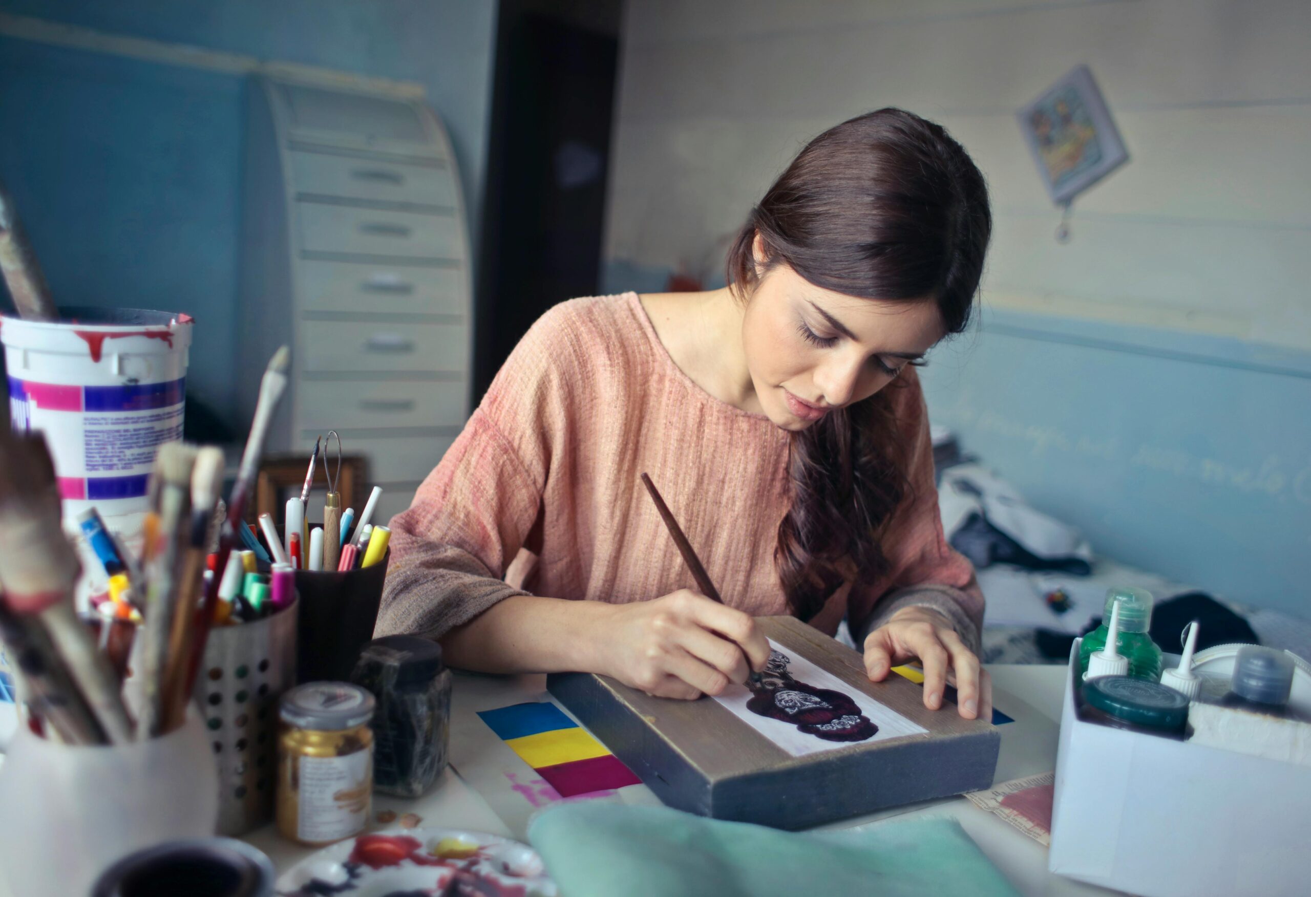 Client engaging in art therapy and cognitive behavioral therapy during a cognitive behavioral session, using creative expression to explore and manage thoughts and emotions.
