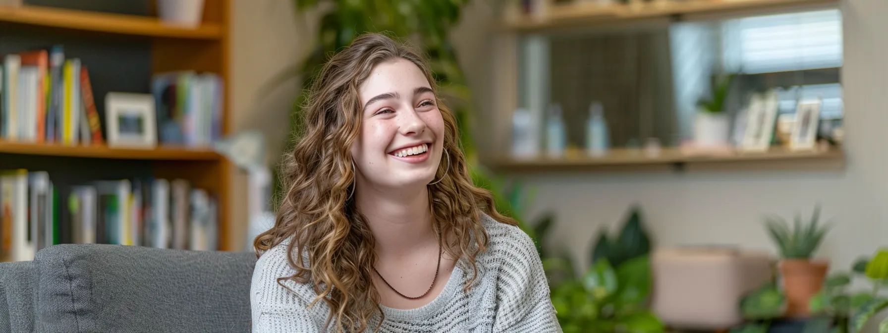 in a serene room, emily smiles brightly as she engages in a focused cognitive behavioral therapy session, surrounded by supportive resources and tools for her transformative journey to wellness.