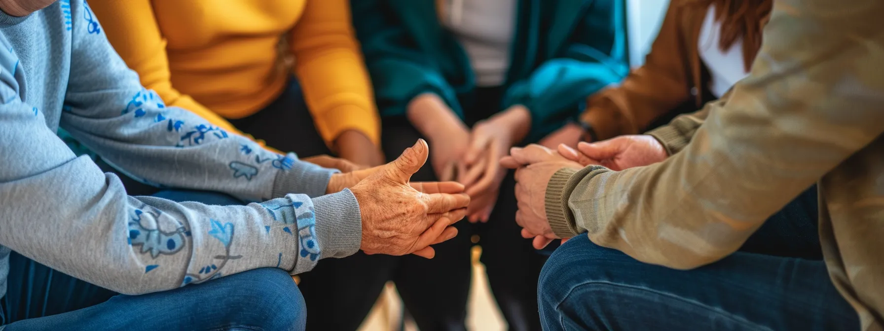 a group of diverse individuals coming together in a circle, offering support and encouragement during an outpatient substance abuse treatment session.
