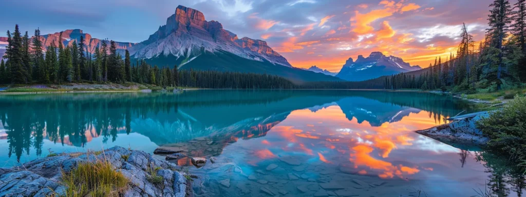 a vibrant sunset casts golden hues over a tranquil lake, reflecting the silhouette of towering mountains against a backdrop of azure sky.