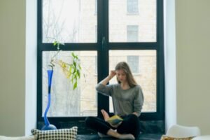 Medication Management for Mental Health: When You Need It and What to Expect 2 A person sitting next to a window in a minimalist setting