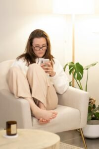 How Medication and IOP Work Together for Anxiety and Depression 5 A woman sitting in a chair holding a cell phone