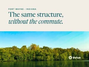 Fort Wayne · Indiana: The same structure, without the commute. Green trees reflected in still water under a blue sky. Thrive.