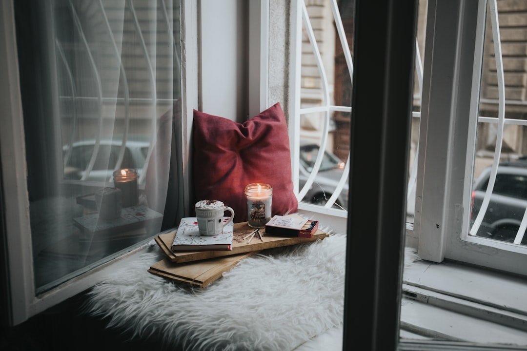 photo of gel candle on board beside pillow.