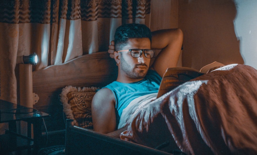 a man sitting in a chair with a laptop.