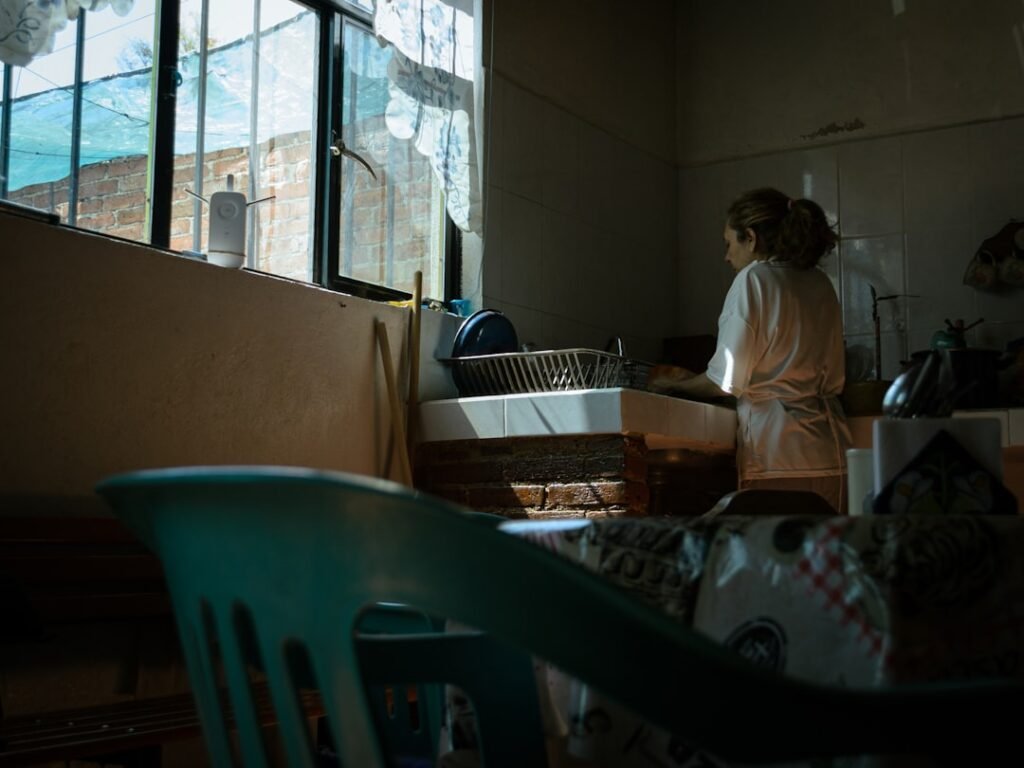 Virtual IOP in Chandler, Arizona 1 Woman doing the dishes in a dimly lit kitchen.