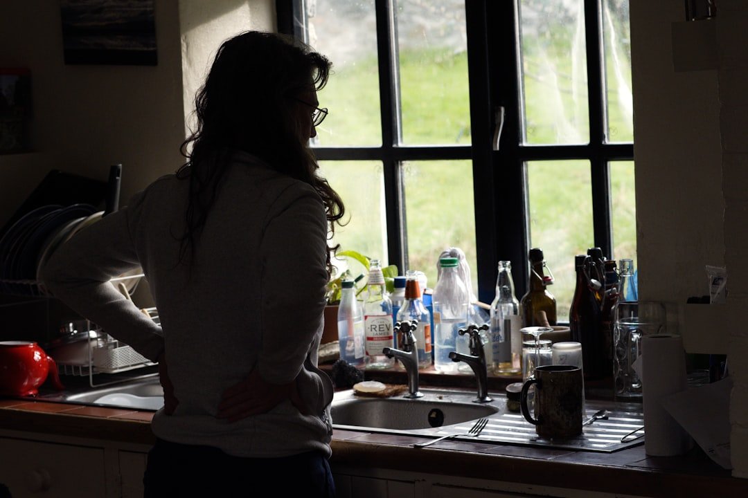 Woman by the window, contemplating.