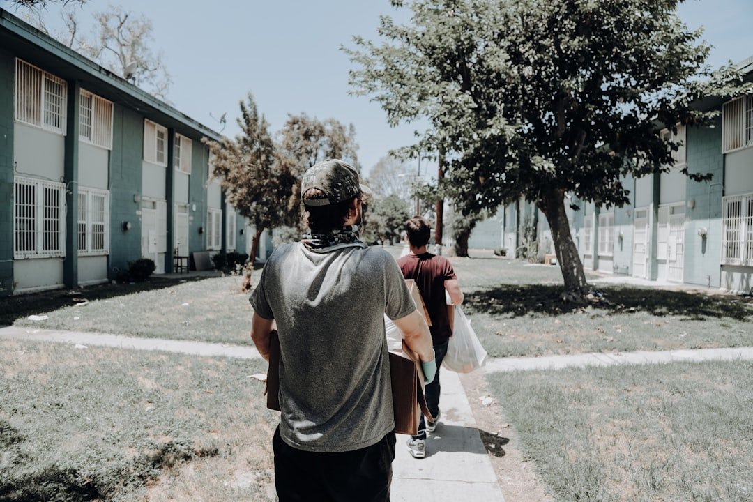 a group of people walking down a sidewalk.