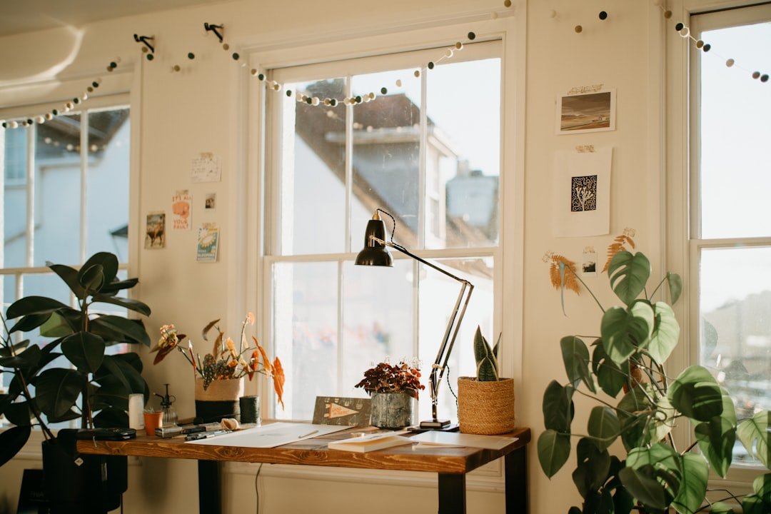 a room filled with furniture and vase of flowers on a table.