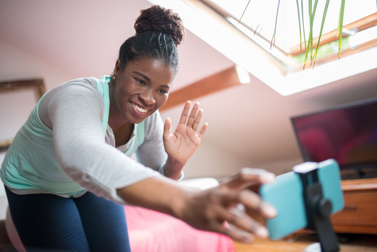 Adult waving hello at the start of a virtual IOP group session covered by Aetna