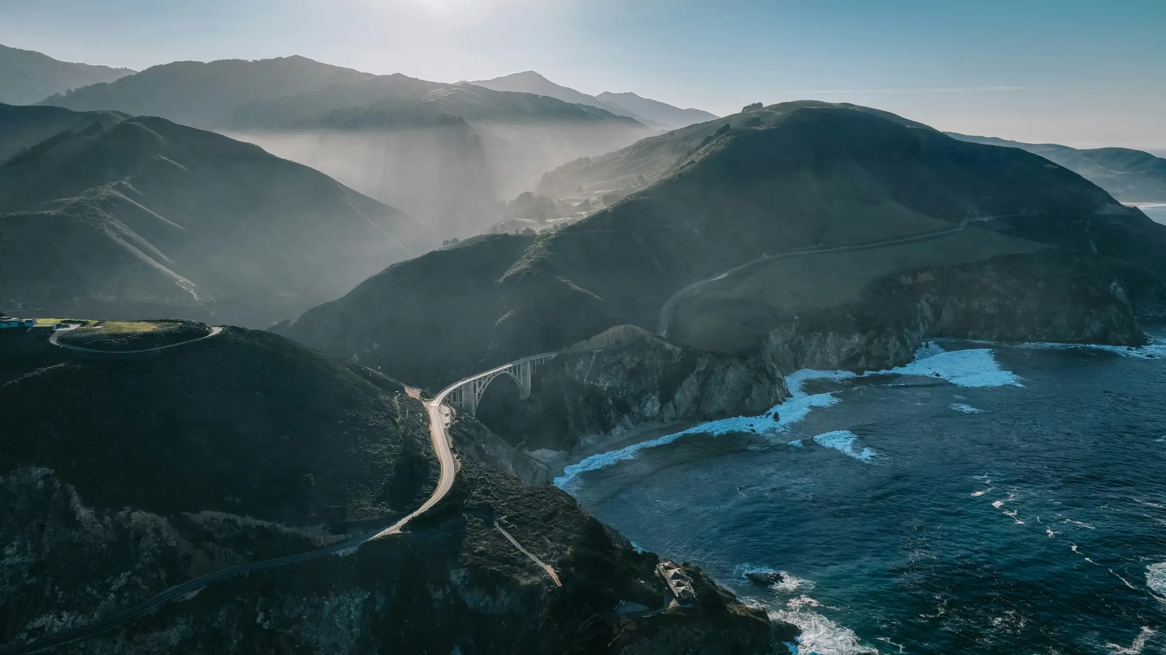 A coastal road winding above the ocean