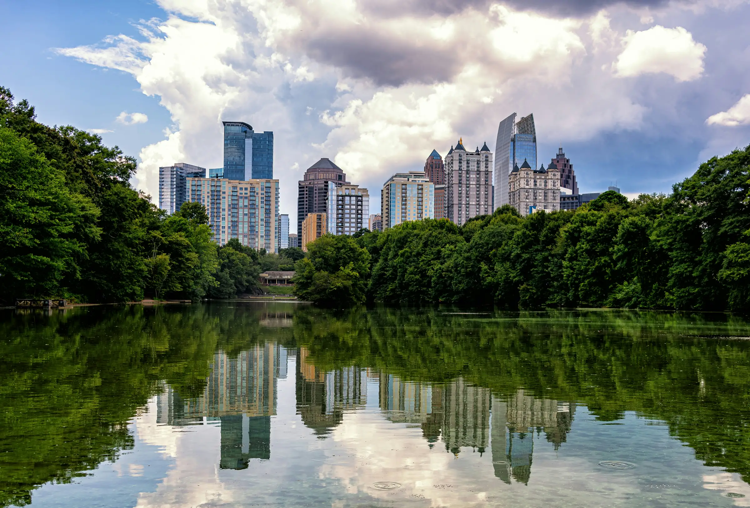 The Atlanta skyline over the lake in Piedmont Park on a bright day