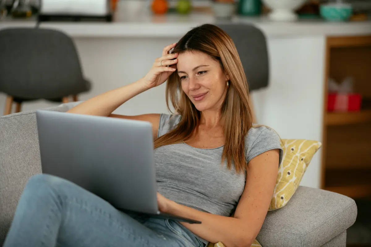 A young woman on a video call from her couch