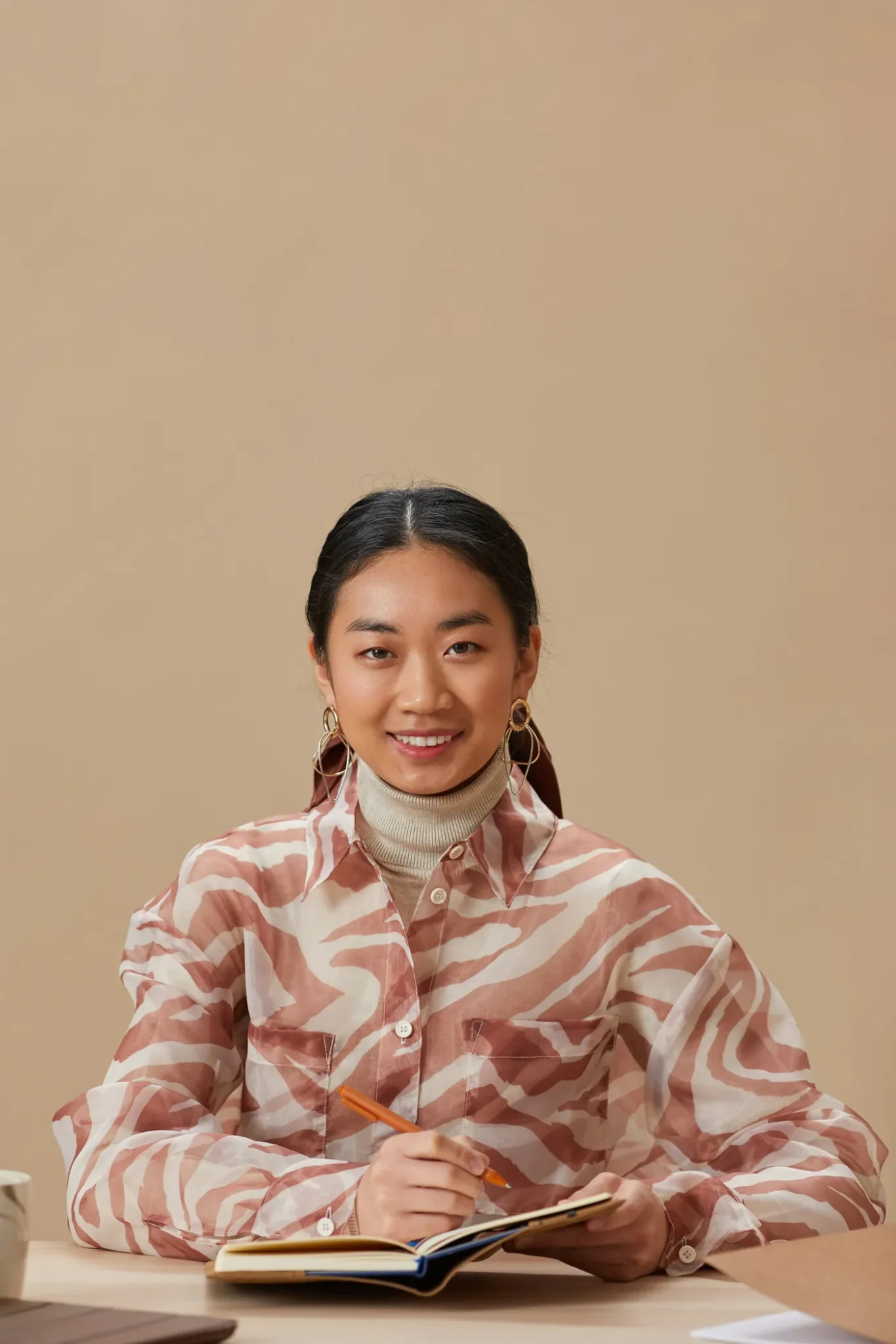 A smiling professional woman taking notes