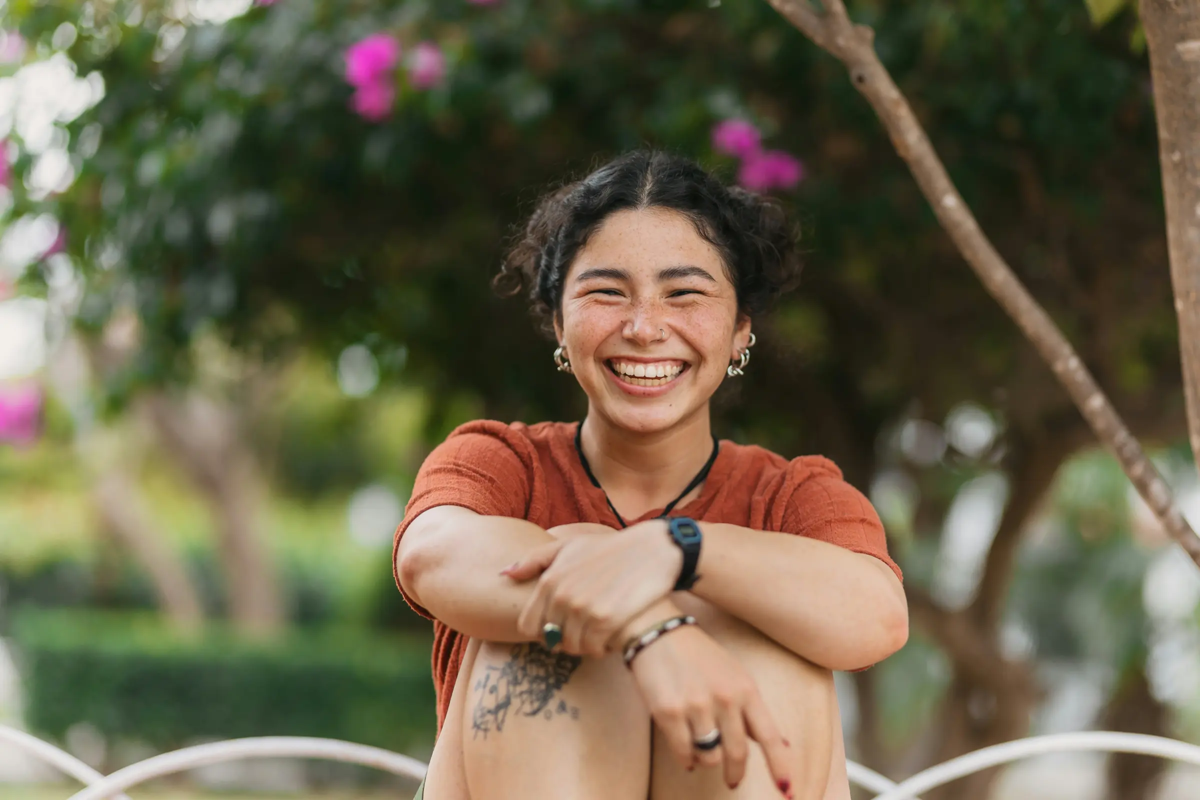 Woman laughing outdoors in a park